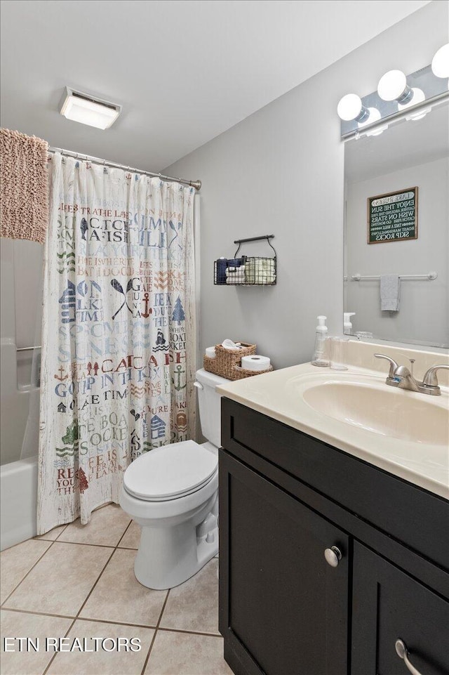 full bathroom with shower / tub combo with curtain, vanity, toilet, and tile patterned flooring