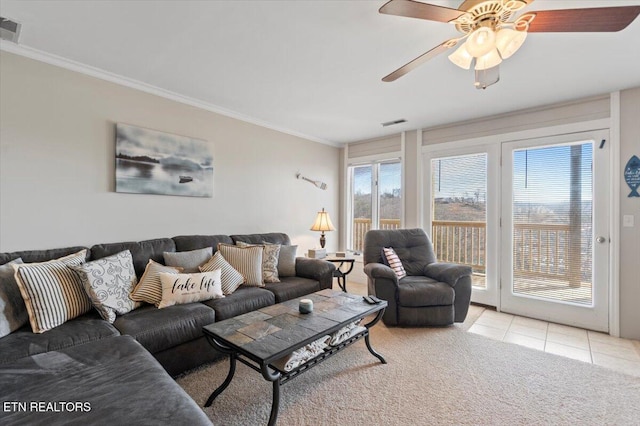 living room with ceiling fan, ornamental molding, and light tile patterned floors