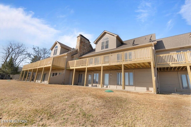 rear view of property featuring a yard