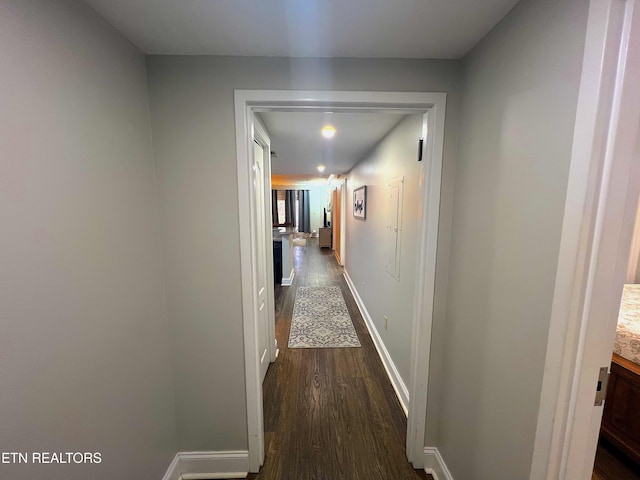 corridor with dark hardwood / wood-style floors