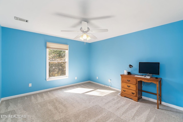 unfurnished office featuring ceiling fan and light colored carpet