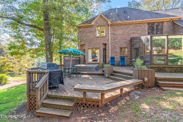 deck featuring area for grilling and a jacuzzi