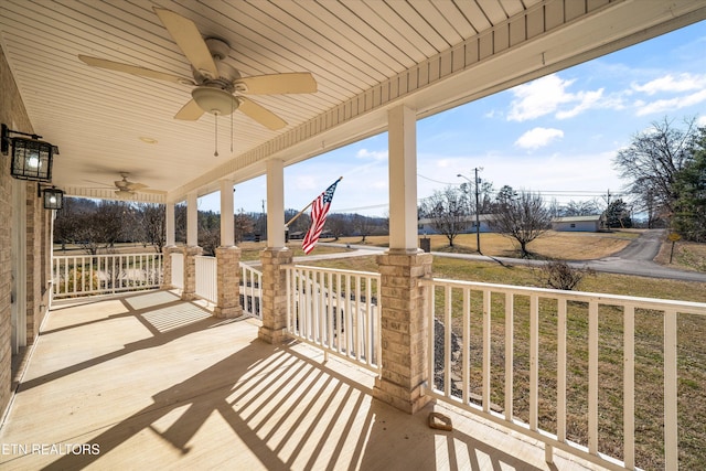 view of patio featuring ceiling fan and a porch