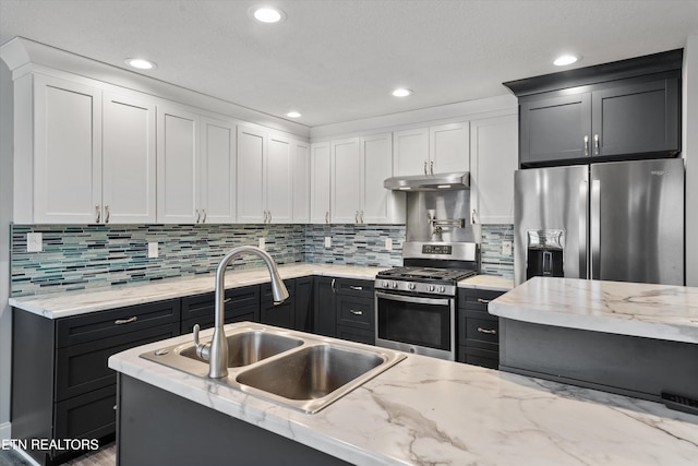 kitchen with white cabinetry, stainless steel appliances, and sink