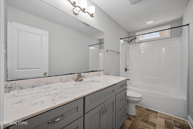 full bathroom with shower / bathtub combination, vanity, toilet, and a textured ceiling