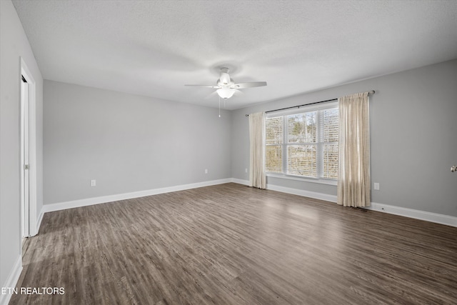 spare room with ceiling fan, dark hardwood / wood-style floors, and a textured ceiling