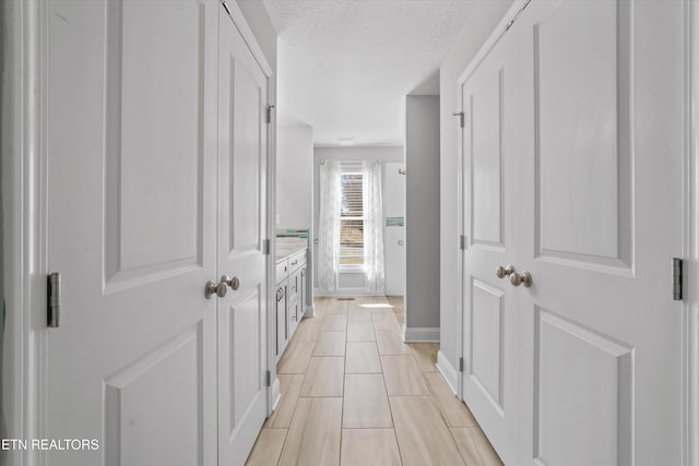 hallway featuring a textured ceiling