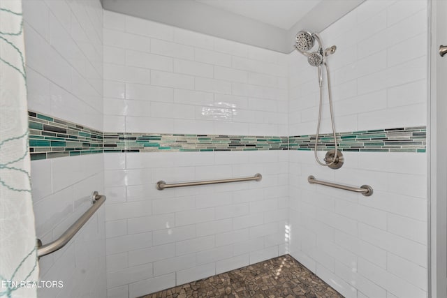 bathroom with a tile shower