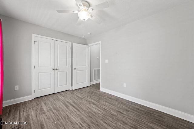 unfurnished bedroom with wood-type flooring, a closet, and ceiling fan