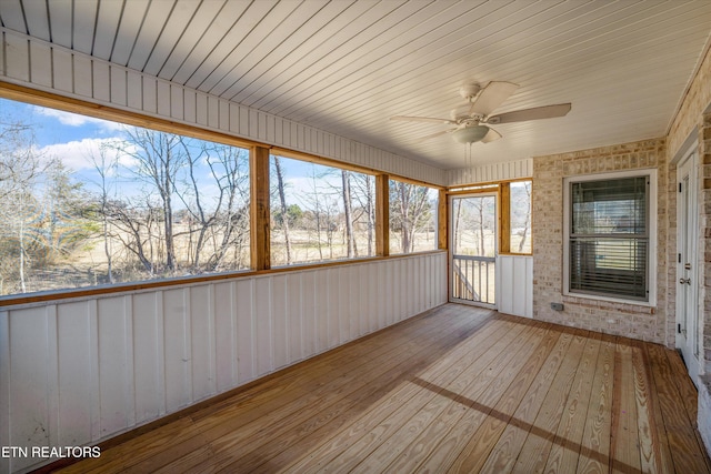 unfurnished sunroom featuring ceiling fan