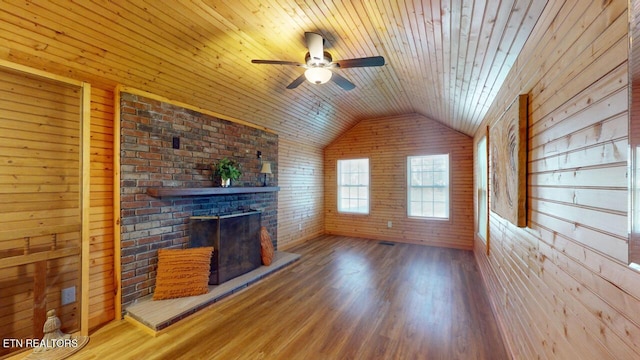 unfurnished living room with lofted ceiling, hardwood / wood-style flooring, ceiling fan, an outdoor brick fireplace, and wooden ceiling