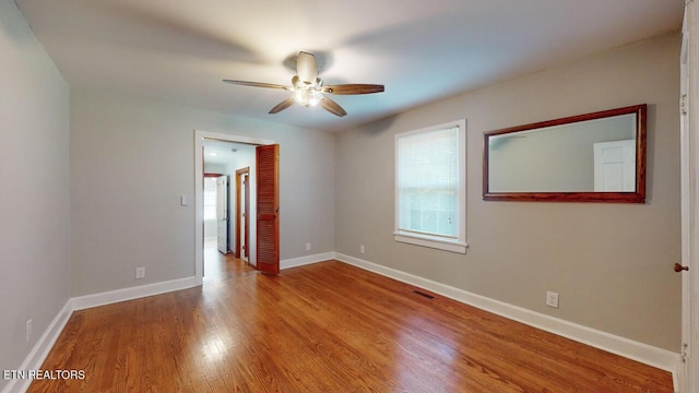 empty room featuring ceiling fan and light wood-type flooring