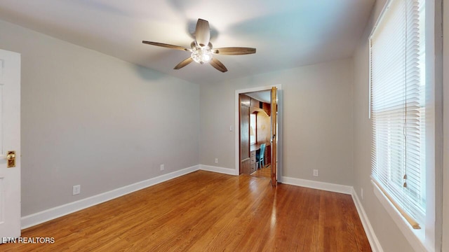 spare room featuring wood-type flooring and ceiling fan