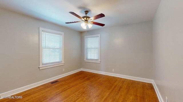 empty room featuring hardwood / wood-style floors and ceiling fan