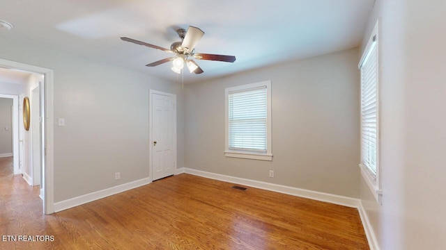 unfurnished room with hardwood / wood-style floors and ceiling fan