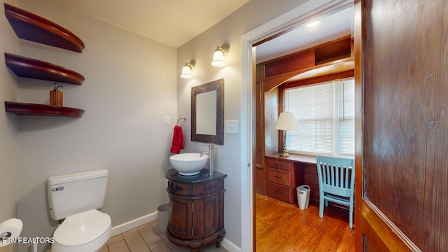 bathroom featuring vanity, toilet, and hardwood / wood-style floors