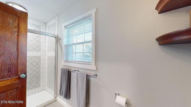 bathroom with a shower with door