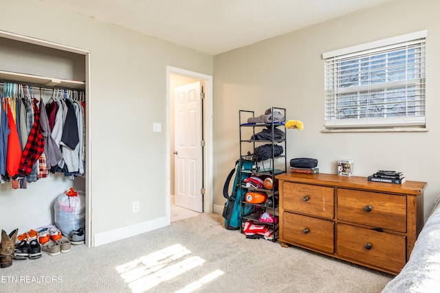 carpeted bedroom with a closet