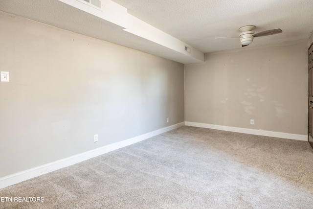 unfurnished room featuring ceiling fan, a textured ceiling, and carpet