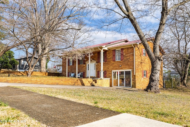 raised ranch with a front lawn