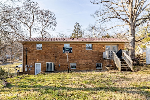 back of house with french doors, a yard, and central air condition unit