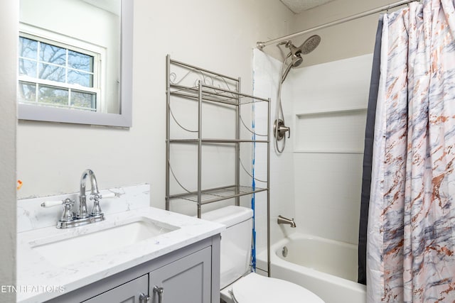 full bathroom with vanity, shower / bath combo with shower curtain, and toilet