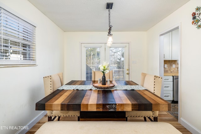 dining area featuring hardwood / wood-style floors and a textured ceiling