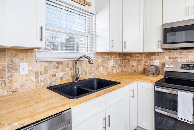 kitchen with white cabinetry, sink, and stainless steel appliances