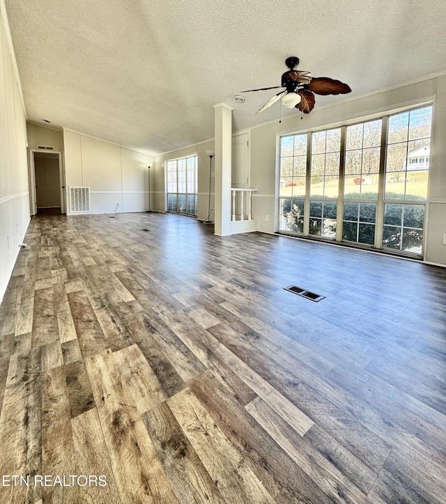 unfurnished living room featuring lofted ceiling, hardwood / wood-style floors, a textured ceiling, and ceiling fan