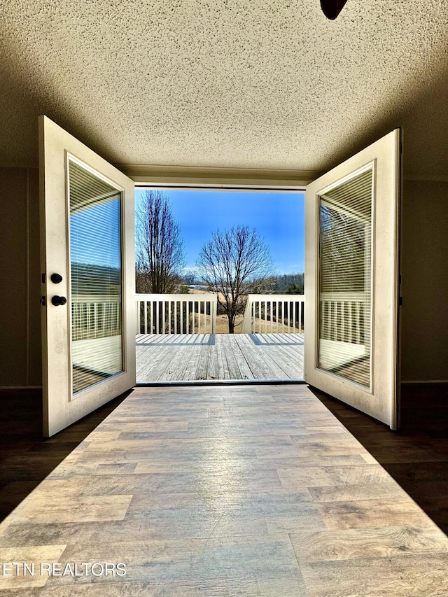 entryway featuring dark hardwood / wood-style flooring and a textured ceiling