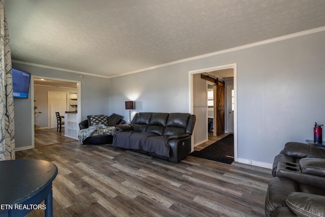 living room featuring ornamental molding, dark hardwood / wood-style floors, and a textured ceiling