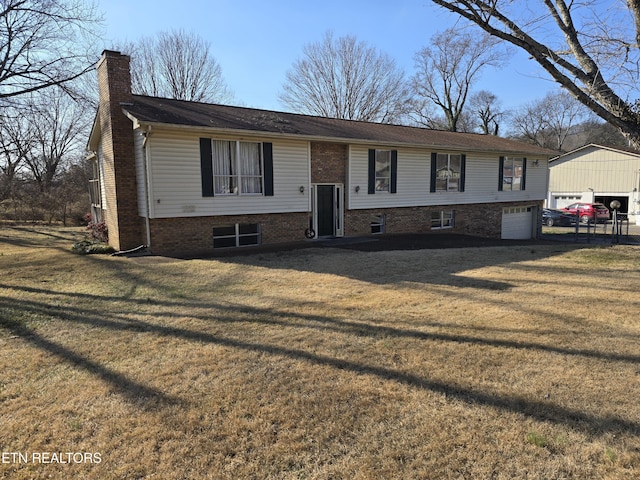 split foyer home with a garage and a front lawn