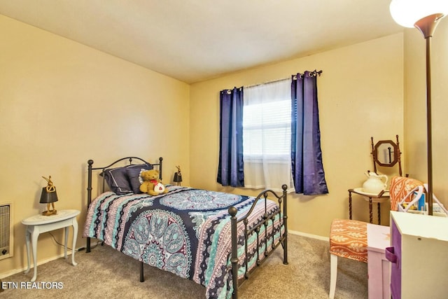 bedroom featuring light carpet