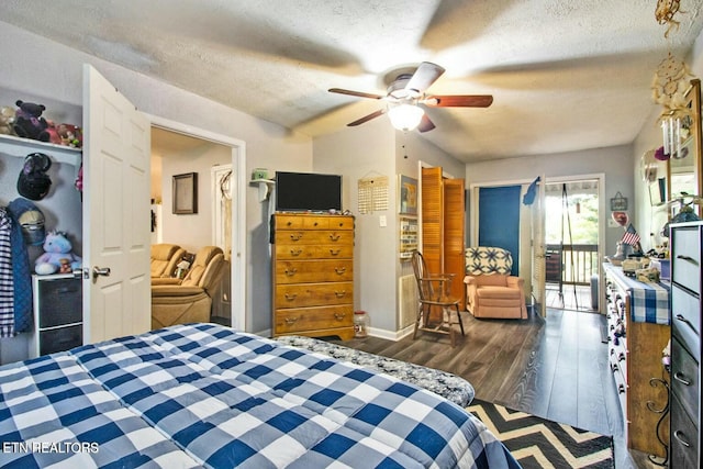 bedroom featuring ceiling fan, dark wood-type flooring, access to exterior, and a textured ceiling