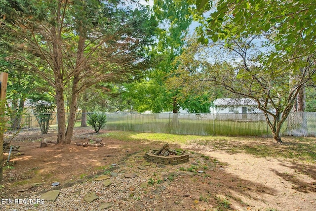 view of yard with an outdoor fire pit