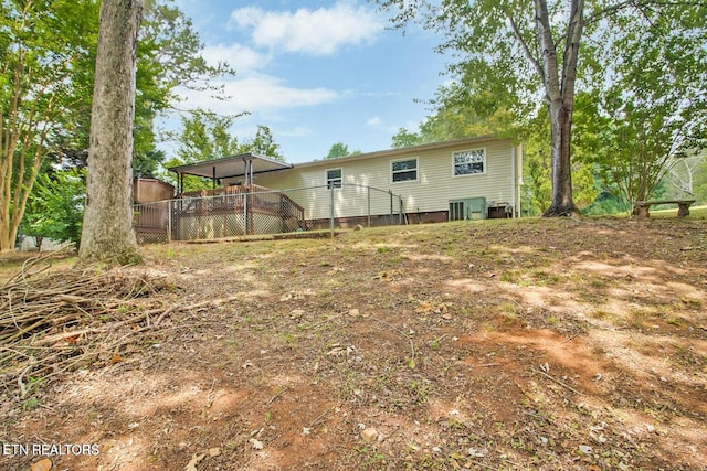 rear view of house with a wooden deck