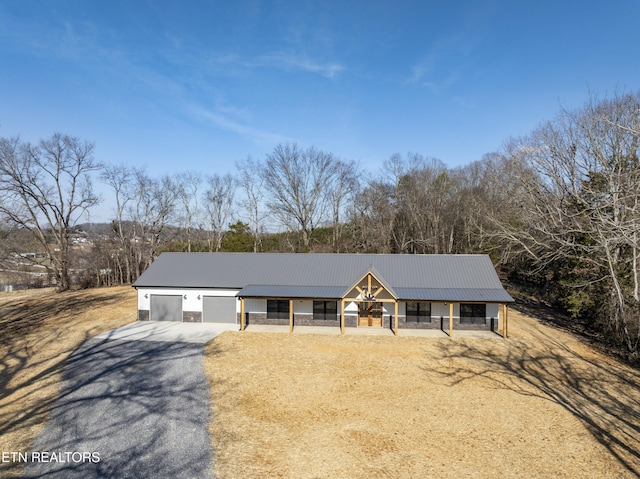 ranch-style home with a garage and covered porch