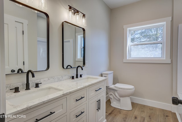 bathroom featuring vanity, hardwood / wood-style flooring, and toilet