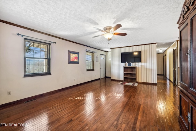 unfurnished living room featuring crown molding, dark hardwood / wood-style floors, and a wealth of natural light