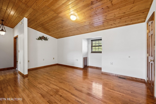 unfurnished room featuring vaulted ceiling, light hardwood / wood-style flooring, and wooden ceiling