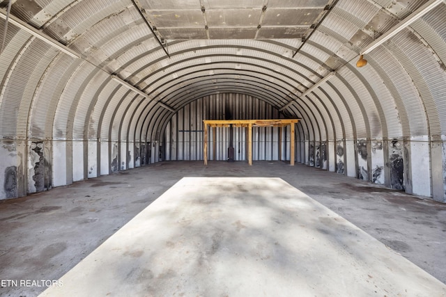 miscellaneous room with lofted ceiling and concrete floors