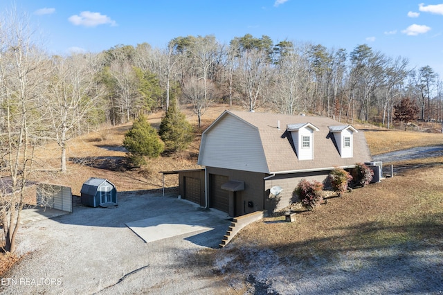 exterior space featuring an outbuilding, a carport, and a garage