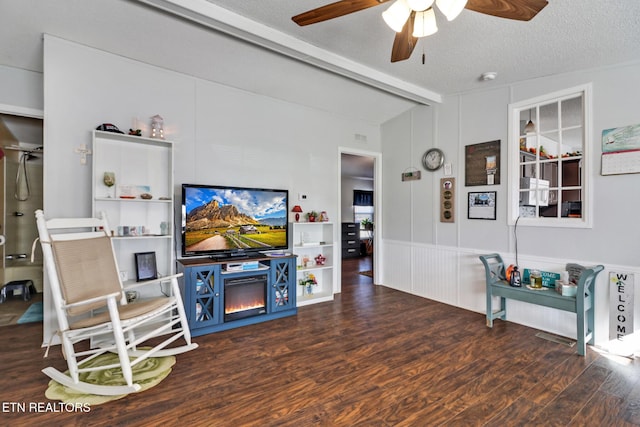 living room featuring vaulted ceiling with beams, dark hardwood / wood-style floors, a textured ceiling, and ceiling fan