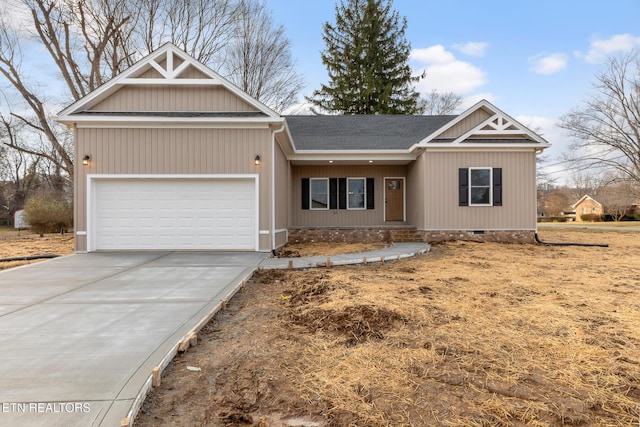 view of front facade featuring a shingled roof, crawl space, driveway, and an attached garage