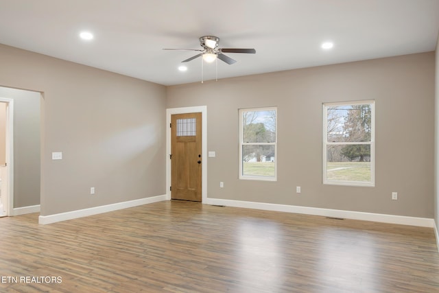 interior space with baseboards, recessed lighting, ceiling fan, and wood finished floors