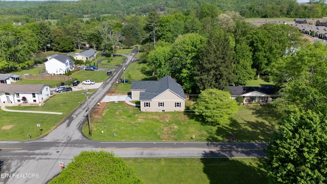 birds eye view of property with a residential view and a wooded view