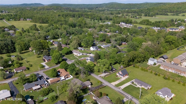 drone / aerial view with a residential view and a forest view