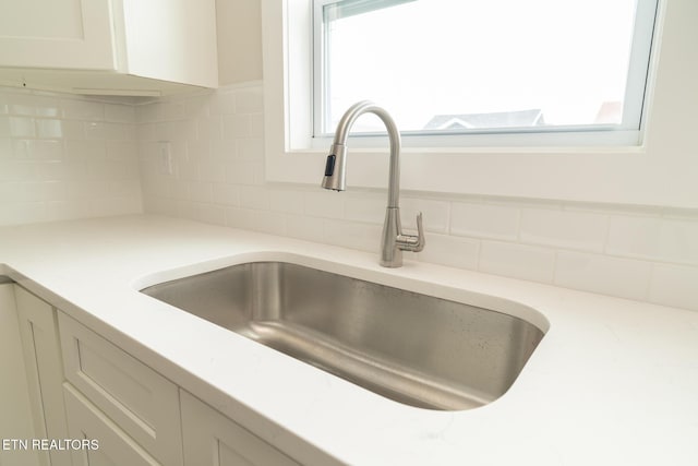 details featuring sink and backsplash