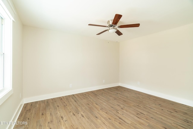 unfurnished room with hardwood / wood-style flooring and ceiling fan