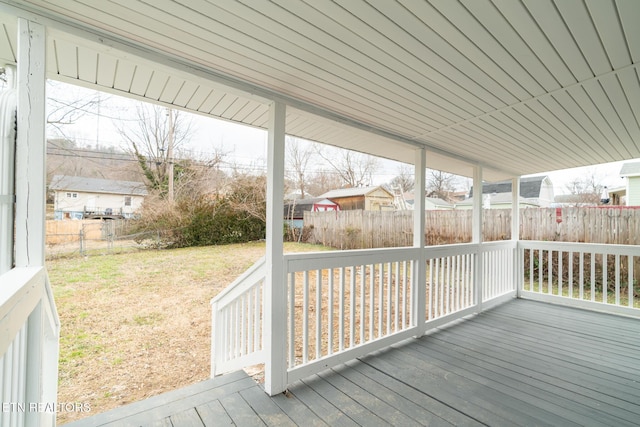 wooden deck with a lawn